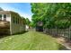Spacious backyard features a treehouse, green lawn and wood fence providing a great space for outdoor activities at 120 Avent Pines Ln, Holly Springs, NC 27540