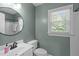 Bathroom featuring a sink, toilet, and a window at 120 Avent Pines Ln, Holly Springs, NC 27540