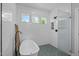The minimalist bathroom features a soaking tub, glass shower, mosaic floor tiles, and subway tiles at 120 Avent Pines Ln, Holly Springs, NC 27540