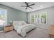 This primary bedroom offers a ceiling fan, a large window, and serene wall paint at 120 Avent Pines Ln, Holly Springs, NC 27540