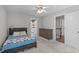 Inviting bedroom featuring a ceiling fan and a dresser with a door that leads to another area at 120 Avent Pines Ln, Holly Springs, NC 27540
