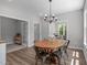 Cozy dining room features a wood table, metal chairs, and a view into another room at 120 Avent Pines Ln, Holly Springs, NC 27540