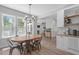 Bright dining room with a wood table, chandelier, and views into the kitchen and living room at 120 Avent Pines Ln, Holly Springs, NC 27540