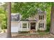 Charming two-story home featuring tan siding, dark shutters, a bay window, and a welcoming front porch at 120 Avent Pines Ln, Holly Springs, NC 27540