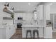 Modern kitchen with white cabinets, stainless steel appliances, and a stylish breakfast bar for casual dining at 120 Avent Pines Ln, Holly Springs, NC 27540