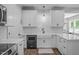 Bright kitchen features white cabinets, subway tile backsplash, apron sink, and stainless steel appliances at 120 Avent Pines Ln, Holly Springs, NC 27540