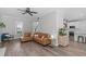Open-concept living room features wood floors and flows into the kitchen, perfect for modern living at 120 Avent Pines Ln, Holly Springs, NC 27540