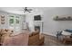 Cozy living room features a fireplace, French doors to the deck, and a comfortable seating arrangement at 120 Avent Pines Ln, Holly Springs, NC 27540
