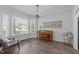 Bright living area with large windows and hardwood floors, perfect for relaxing or entertaining guests at 120 Avent Pines Ln, Holly Springs, NC 27540