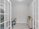 Office with French doors, desk, bookshelf, and natural light at 120 Avent Pines Ln, Holly Springs, NC 27540