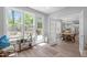Sunroom featuring large windows, access to the back deck, and dining room at 120 Avent Pines Ln, Holly Springs, NC 27540