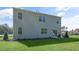 Exterior view of the home showcasing a lush lawn and a cozy patio with outdoor seating at 1205 Pavo Path, Wendell, NC 27591