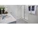 Bright bathroom featuring a double vanity, shower with glass doors, and modern fixtures at 1205 Pavo Path, Wendell, NC 27591