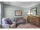 Charming Bedroom displays crib, map art, dresser, and cozy seating at 1205 Pavo Path, Wendell, NC 27591