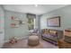 Inviting Bedroom shows crib, chair, pouf, world map and bright natural light at 1205 Pavo Path, Wendell, NC 27591