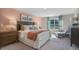 Comfortable bedroom with a large window, chair, and stylish furniture at 1205 Pavo Path, Wendell, NC 27591