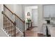 The entryway features a console table, stairs with wood railings, and a view of the front door at 1205 Pavo Path, Wendell, NC 27591