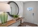 Welcoming entryway with a decorative mirror, console table with decor, and a view of the front door at 1205 Pavo Path, Wendell, NC 27591