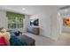 Well-lit living room showcases a modern TV and plush seating by window at 1205 Pavo Path, Wendell, NC 27591