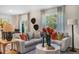 The living room features a plush sofa, decorative coffee table, and large windows that let in natural light at 1205 Pavo Path, Wendell, NC 27591