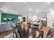 Open-concept living space with a dining area, kitchen, and stairs creates a spacious and inviting atmosphere at 1205 Pavo Path, Wendell, NC 27591