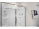 Bright, clean shower with glass door, built-in shelving, and chrome fixtures at 1205 Pavo Path, Wendell, NC 27591
