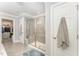 Modern bathroom featuring glass shower, tile floors, and walk in closet at 121 Woodstaff Ave, Wake Forest, NC 27587