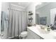 Clean bathroom featuring a white vanity, updated fixtures, and a shower with a gray curtain at 121 Woodstaff Ave, Wake Forest, NC 27587