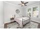 Serene bedroom with a metal frame bed, neutral colors, and natural light from the windows at 121 Woodstaff Ave, Wake Forest, NC 27587