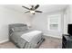 Comfortable bedroom with ceiling fan, soft lighting, and cozy gray decor at 121 Woodstaff Ave, Wake Forest, NC 27587