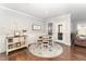 Cozy dining area with a round table, wainscoting, and a decorative rug at 121 Woodstaff Ave, Wake Forest, NC 27587