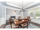 Formal dining room featuring elegant chandelier, wood table, and beautiful rug, perfect for entertaining at 121 Woodstaff Ave, Wake Forest, NC 27587
