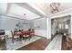Elegant dining area with a wooden table, stylish rug, tray ceiling and natural light at 121 Woodstaff Ave, Wake Forest, NC 27587