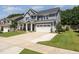 Charming two-story home with a two car garage, lovely landscaping, and a well-maintained lawn at 121 Woodstaff Ave, Wake Forest, NC 27587