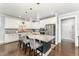 Modern kitchen with a large island, granite countertops, stainless steel appliances and pendant lighting at 121 Woodstaff Ave, Wake Forest, NC 27587