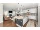 Open-concept kitchen with granite island, stainless steel appliances, flowing into the living area with fireplace at 121 Woodstaff Ave, Wake Forest, NC 27587