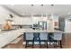 Spacious kitchen featuring a large island, stainless steel appliances, white cabinetry and pendant lighting at 121 Woodstaff Ave, Wake Forest, NC 27587