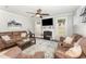 Spacious living room with a fireplace, ceiling fan, ample seating, and natural light at 121 Woodstaff Ave, Wake Forest, NC 27587