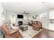 Comfortable living room featuring a fireplace, ceiling fan and plush leather seating at 121 Woodstaff Ave, Wake Forest, NC 27587