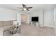 Cozy living room features neutral tones, plush seating, and a ceiling fan at 121 Woodstaff Ave, Wake Forest, NC 27587