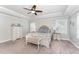 Bright main bedroom features tray ceilings, a ceiling fan, and matching bedside tables at 121 Woodstaff Ave, Wake Forest, NC 27587