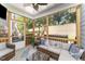 Relaxing screened porch with cozy seating, ceiling fan, and views of the well-maintained backyard at 121 Woodstaff Ave, Wake Forest, NC 27587