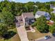 Aerial view of a stunning two-story home with a three car garage and mature landscaping at 1221 Tartarian Trl, Apex, NC 27502