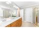 Bright bathroom with double vanity, large mirror, tile floor, and separate shower at 1221 Tartarian Trl, Apex, NC 27502
