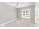 Bedroom with light gray walls, carpet, ceiling fan, and a large window at 1221 Tartarian Trl, Apex, NC 27502