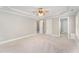 Spacious bedroom boasts neutral carpet, ceiling fan, and multiple entryways at 1221 Tartarian Trl, Apex, NC 27502