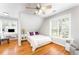 Cozy bedroom with wood floors, a ceiling fan, and a comfortable bed at 1221 Tartarian Trl, Apex, NC 27502