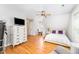 Spacious bedroom with hardwood floors, desk, and a comfortable bed at 1221 Tartarian Trl, Apex, NC 27502