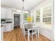 Bright breakfast nook features a granite table, white chairs, and sunlit windows with views at 1221 Tartarian Trl, Apex, NC 27502