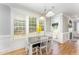 Bright dining area featuring a table, chairs, natural light, and a door to the backyard at 1221 Tartarian Trl, Apex, NC 27502